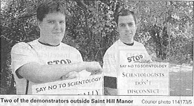 Two protesters in front of Saint Hill Manor