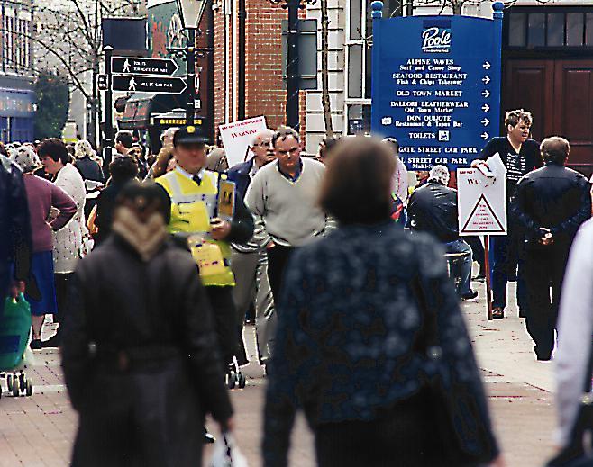 Long shot of pedestrians and protest